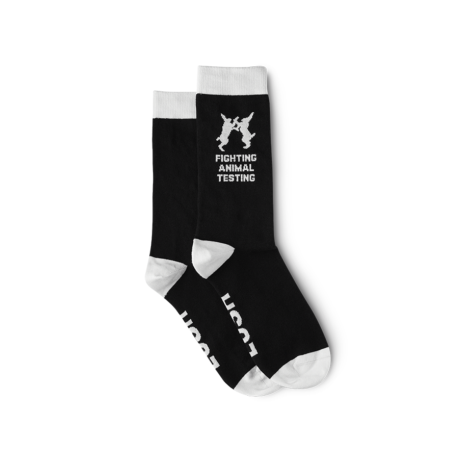 Black socks with the toe, heel and tops white. “Lush” is on the soles with ‘Fighting Animal Testing’ logo and text on the ankle.