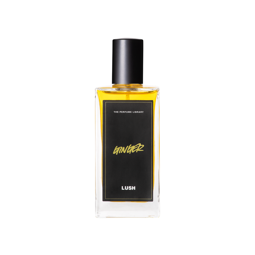 A glass perfume bottle filled with a light amber liquid. A black label reads 'The Perfume Library' and 'Ginger'.