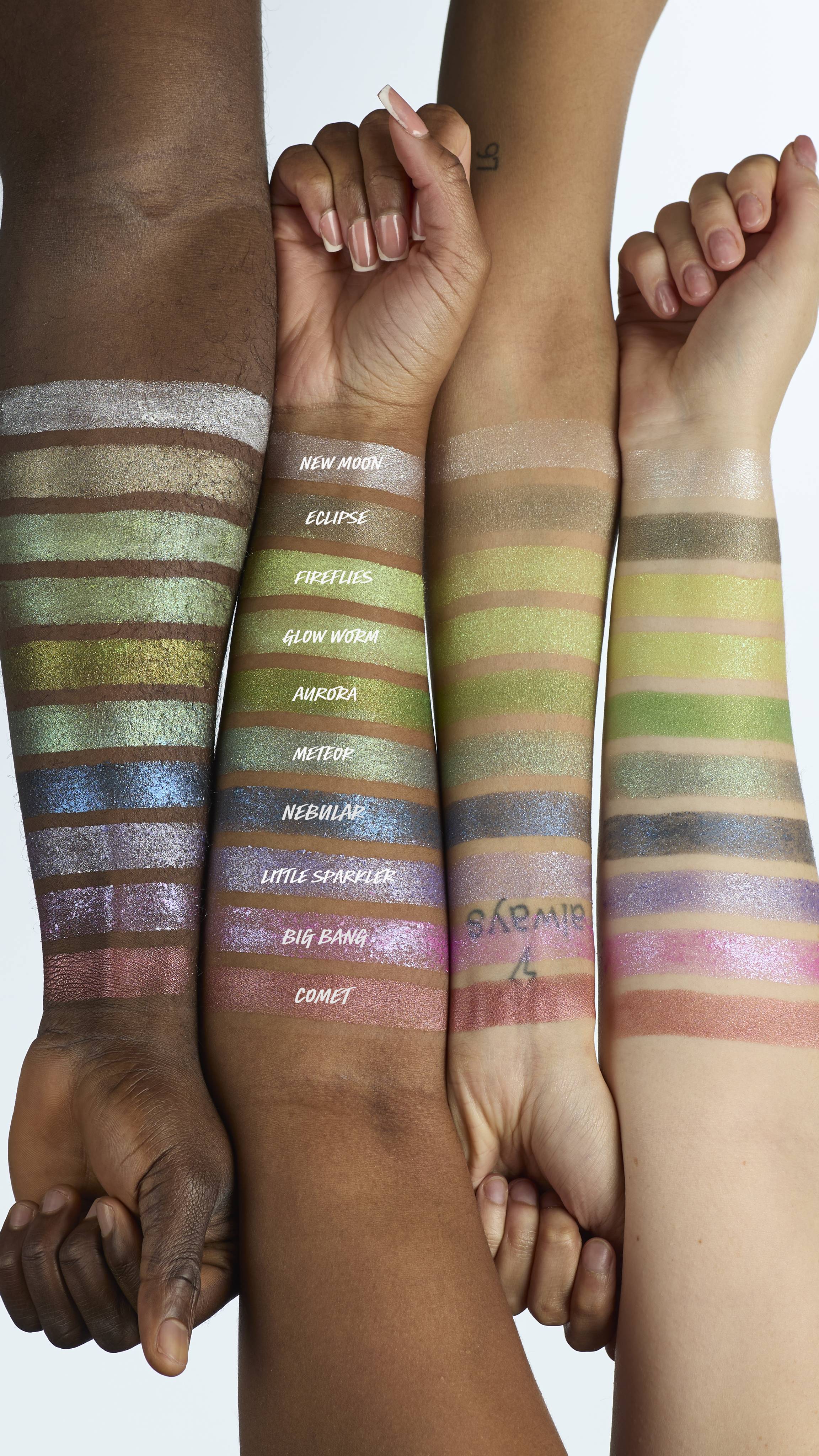 The image shows four model's forearms laid next to each other in varying shades of skin colour. There is a line of ten Glitter Crumble swatches across all four arms to showcase how each product colour shows up on different skin tones.