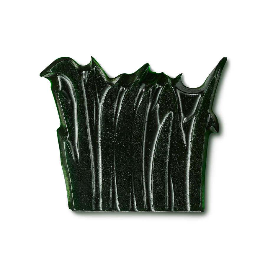 Grounding. A dark forest green shower gummy stands against a plain black background. The product has a heavily textured, sculpted surface with deep vertical grooves and a jagged, wavy top edge resembling blades of grass.