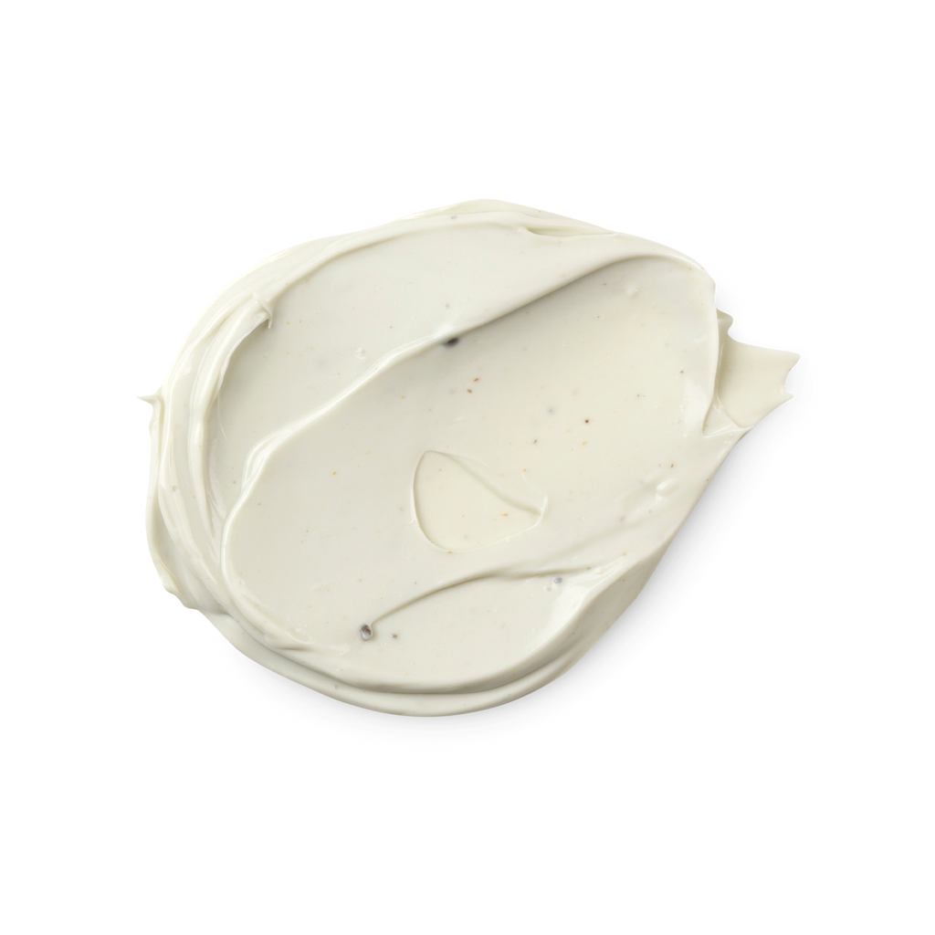 A swatch of thick, cream tinted with mint green Handy Gurugu hand cream. Some tiny dark brown flecks can be seen in the mixture.