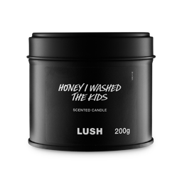Honey I Washed The Kids. A round, black, candle tin with a removable lid. The black label on the front reads "Honey I Washed The Kids Scented Candle" in white text.