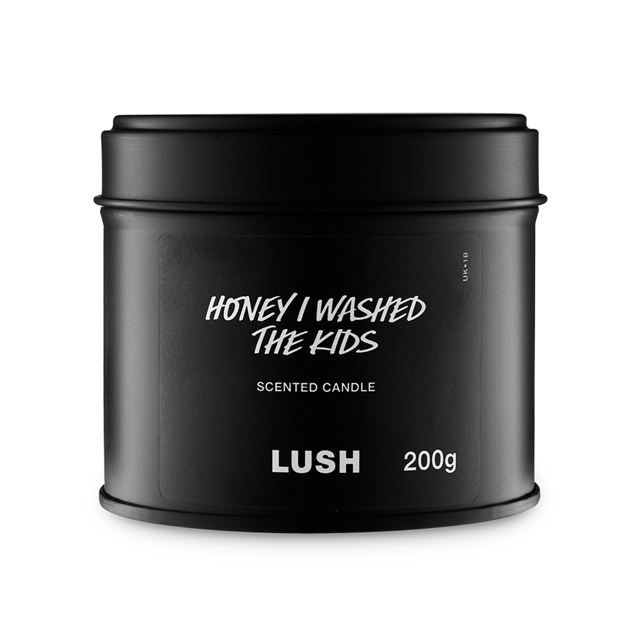 Honey I Washed The Kids. A round, black, candle tin with a removable lid. The black label on the front reads "Honey I Washed The Kids Scented Candle" in white text.