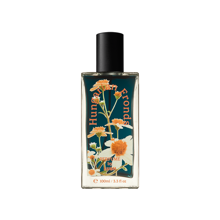 Hungarian Fronds. A rectangular, glass perfume bottle with a black cap is filled with translucent, deep-blue liquid. The name "Hungarian Fronds" is arched in orange on the front of the bottle along with flower decals.