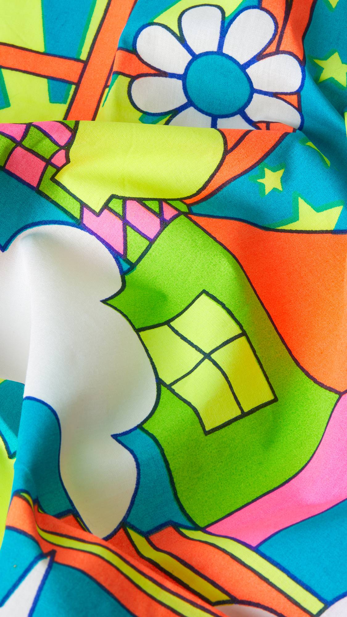 A super close-up image of the Joyous Springtime knot wrap with the lighting focusing on the texture of the material and the vibrant colours.