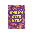 Karma Over Here. A purple postcard with a paisley-style pattern and the words "Karma Over Here" printed in yellow.