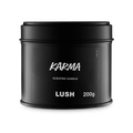 Karma. A round, black, candle tin with a removable lid. The black label on the front reads "Karma Scented Candle" in white text.