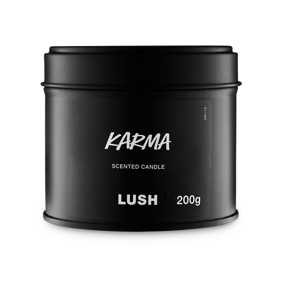 Karma. A round, black, candle tin with a removable lid. The black label on the front reads "Karma Scented Candle" in white text.