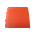Karma. A deep orange, smooth, trapezium shaped soap, with bumps along its left side.