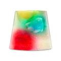 A translucent, trapezoidal-shaped shower jelly containing vibrant star-shaped Luma figures in yellow, green, blue, and red. The entire jelly is filled with shimmering plastic-free glitter