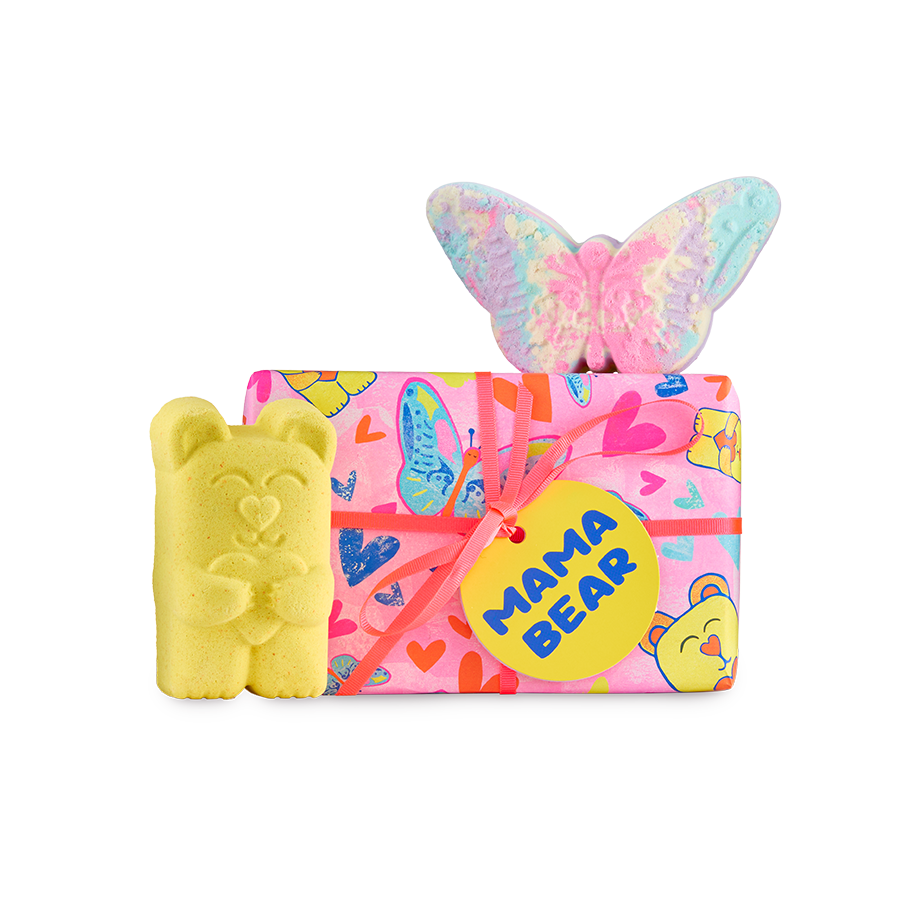 Mama Bear gift. A rectangular gift wrapped in pink heart, bear and butterfly paper, a yellow bear-shaped bath bomb, and a pastel-coloured butterfly bath bomb, tied with a pink ribbon.
