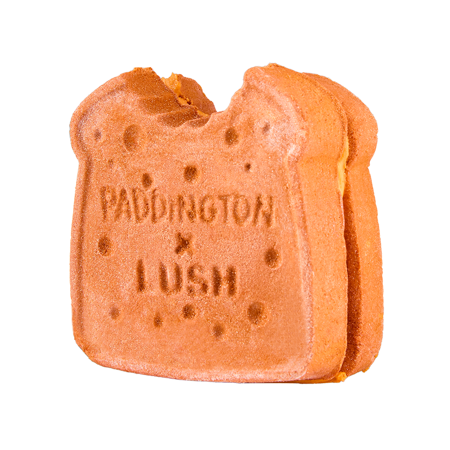 Marmalade Sandwich. A brown, sandwich-shaped bubbleroon bubble bar with a small bite taken out of the top corner. The textured surface features the embossed text ‘PADDINGTON x LUSH’ and bread texture detail.