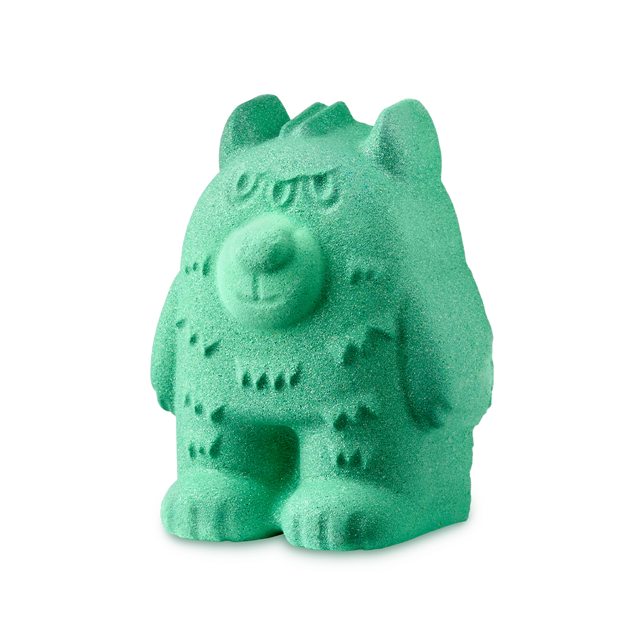 Monster Scare Bear. A bright mint-green bath bomb sculpted into the shape of a chunky bear. It has small pointed ears, textured fur details on its body, and a rounded snout, with three eyes.