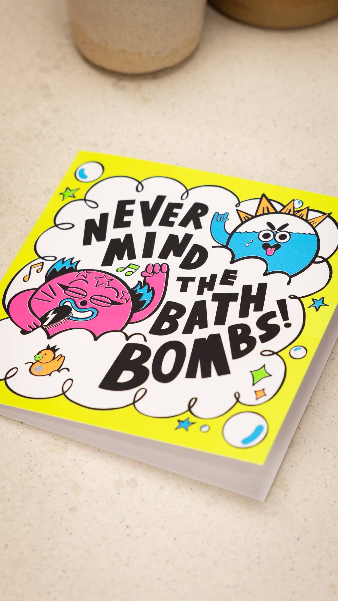 Image shows a close-up of the super colourful card laid flat on a table.