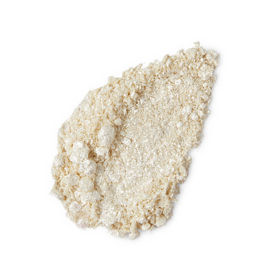 New Moon Glitter Crumble. A neatly smudged swatch of crumbly, shimmering, ivory-coloured metallic eyeshadow.