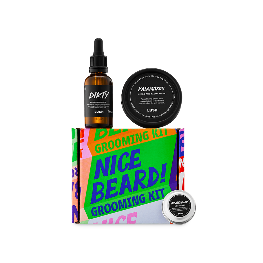 A Lush 'Nice Beard!' Grooming Kit featuring a bright, typographic box in multiple bright colours. The set includes a glass bottle of Dirty hair and beard oil, a tub of Kalamazoo beard and facial wash, and a small tin of Cosmetic Lad moisturiser.