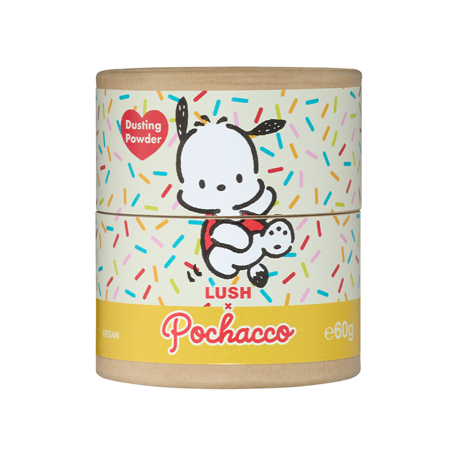Pochacco. A cardboard shaker tube of Lush x Pochacco dusting powder against a black background. It features the cartoon character Pochacco on a colourful sprinkle pattern, with a red heart label reading "Dusting Powder" and a yellow band at the base.
