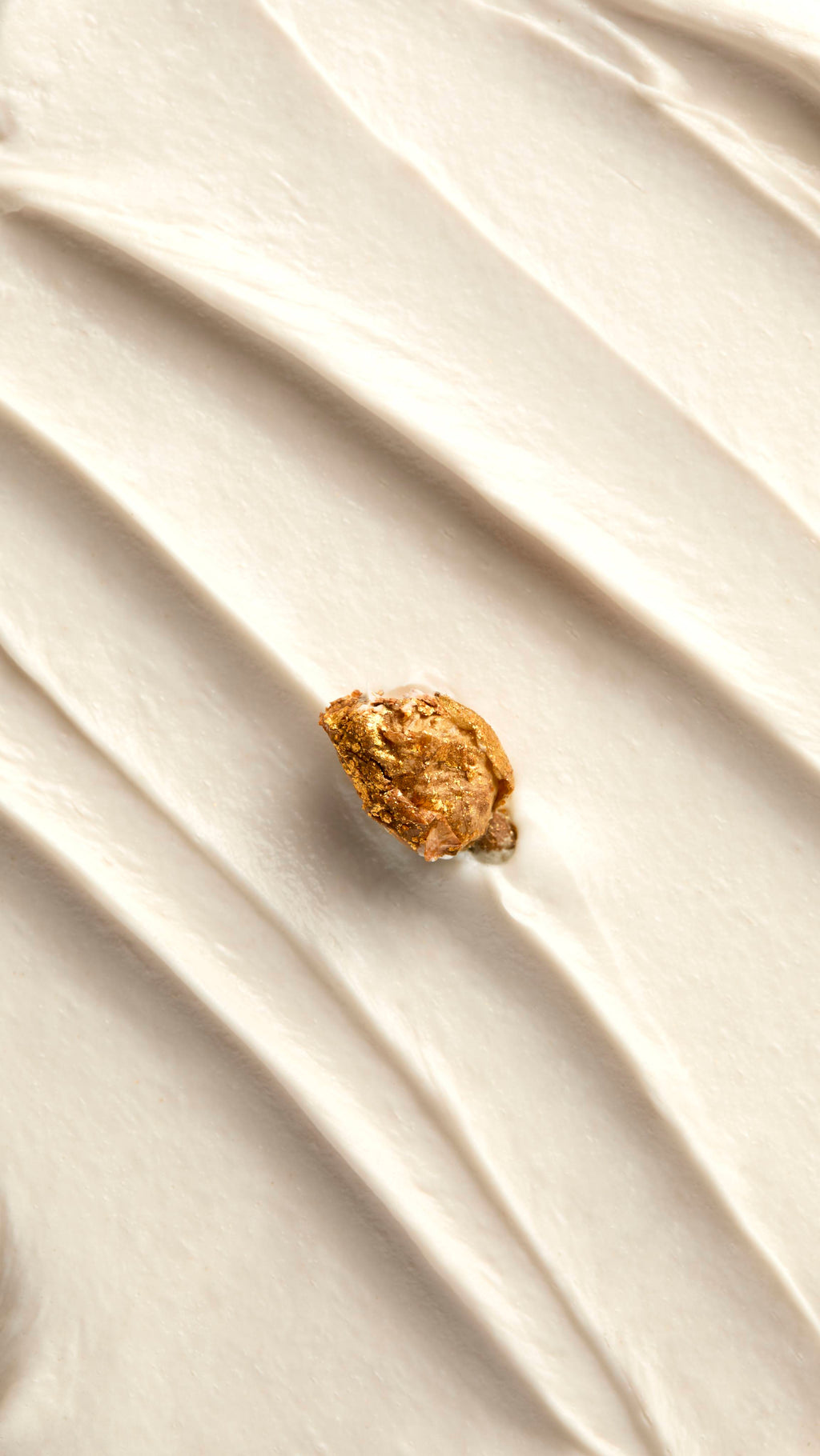 A close-up shot displays the thick, creamy white texture of the "Posh White Chocolate and Rose" body wash, spread into diagonal ridges. A single dried rose bud, dusted with gold shimmer, rests in the center of the mixture.