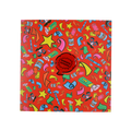 Practical Joker. A square greetings card with a bright red background. The card has illustrations of accessories associated with practical jokes including false gum and confetti. In the centre is a detachable, red, whoopee cushion pin badge.
