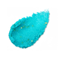 Vibrant turquoise, granular lip scrub smear on a black background. Filled with tiny, shimmering gold star-shaped glitters.