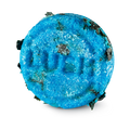Seanik. A circular, bright blue Lush solid shampoo bar embossed with the word 'LUSH' in the centre. The highly textured bar is speckled with pieces of dark green seaweed.