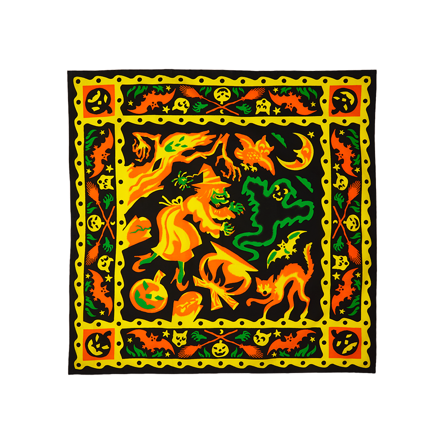 Season of the Witch knot wrap. A square fabric wrap with a vibrant, witch-themed Halloween illustration. Bright yellow, orange, and green figures including a witch, cauldron, ghost, and cat are framed by a decorative yellow border.
