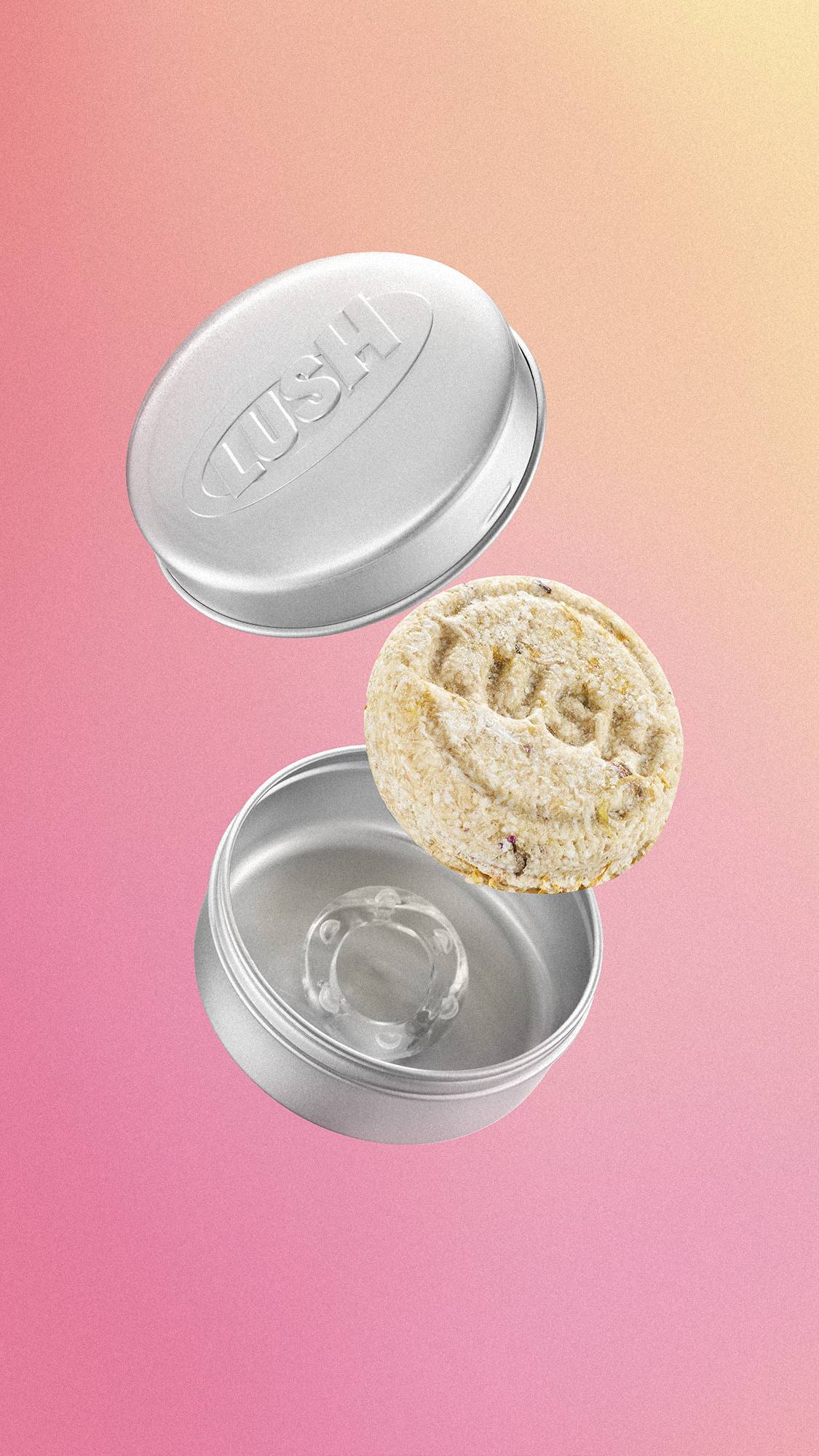 A circular, textured cream Lush shampoo bar floats mid-air between an open, embossed silver aluminium storage tin and its lid. The items are suspended against a soft, smooth pink and yellow gradient background.
