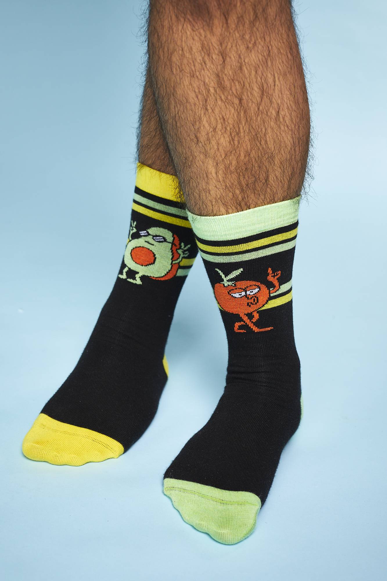 A shot of the model's calves down shows them standing on tip toes showing the Fresh Values socks.