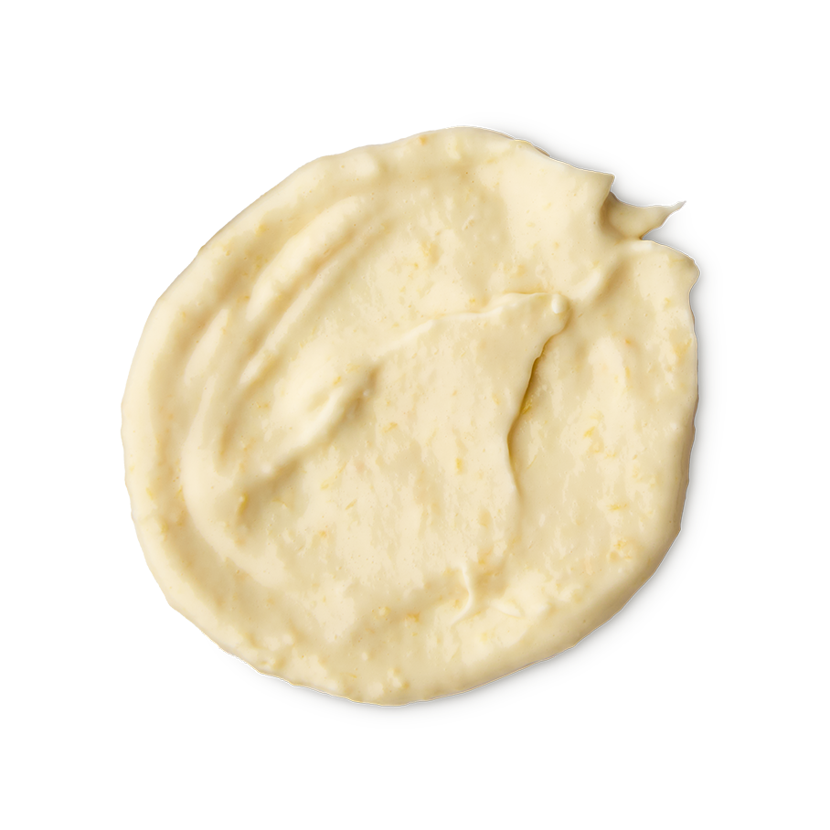 St Clements. A rounded, smeared swatch of thick, pale yellow hair treatment mask with a smooth, slightly textured finish. The swatch shows visible streaks from being spread.