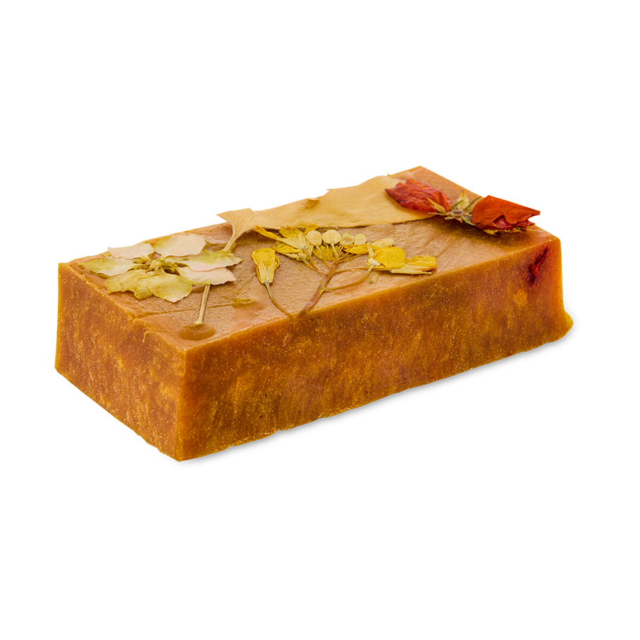 Sticky Syrup. A golden, caramel-coloured slab or rectangle soap with pressed, dried flowers on top.