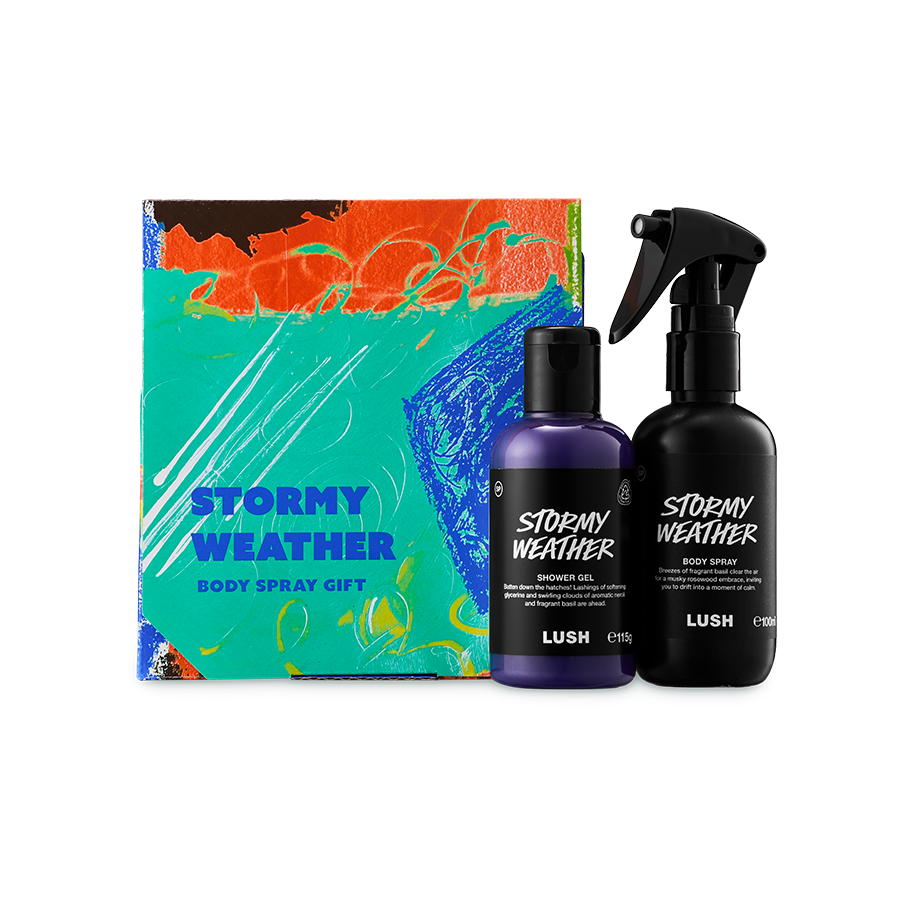 Stormy Weather. A colourful abstract box in teal, orange, and blue. Beside it stands a bottle of purple "Stormy Weather" shower gel and a black bottle of body spray of the same name. Both items feature white text on black labels.