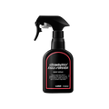 A recycled black plastic LUSH body spray bottle with a trigger nozzle stands upright with a red rimmed label with white text that reads "Strawberry Feels Forever Body Spray".