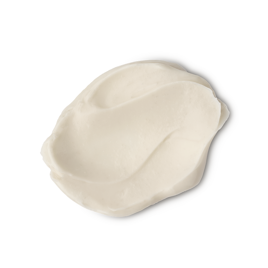 A studio shot of a textured swatch of LUSH Supermilk hair conditioner, a pale, off-white product, against a light gray background.