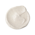 A swatch of light cream coloured Sympathy for the Skin body lotion, with tiny dark brown flecks, which are vanilla pod seeds.