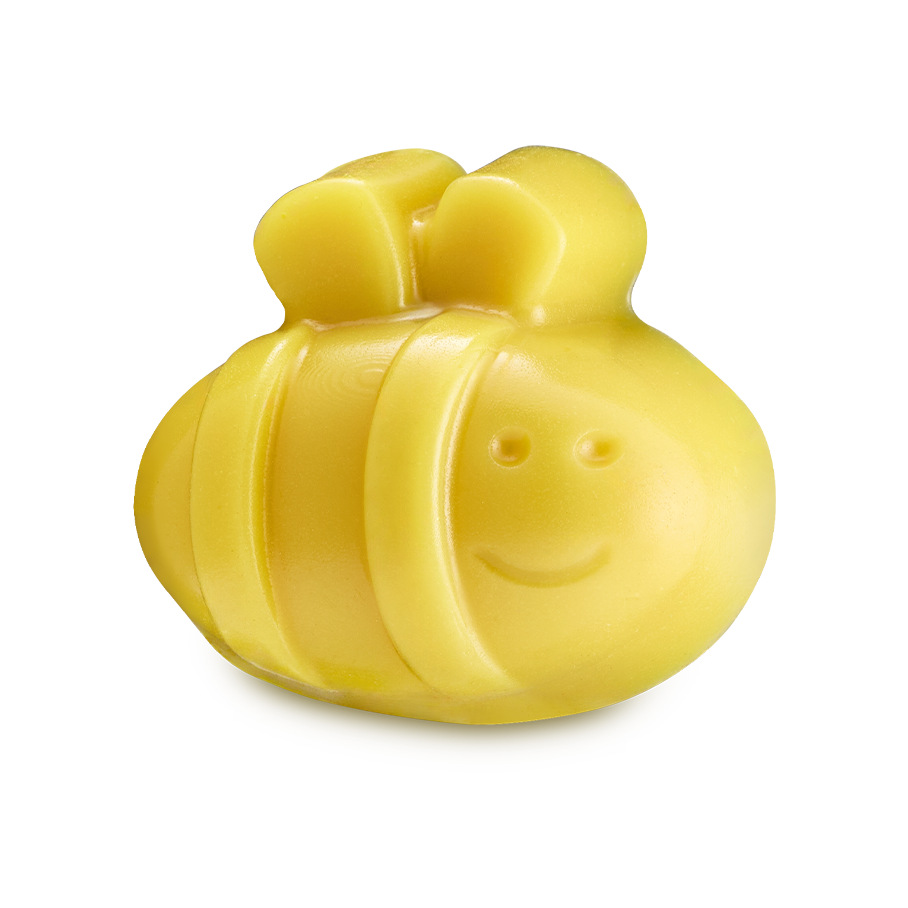 Telling The Bees. A bright yellow, bee-shaped facial gummy wash. The bee has a rounded body with raised stripes, small wings on top, and a simple debossed smiley face on the front.