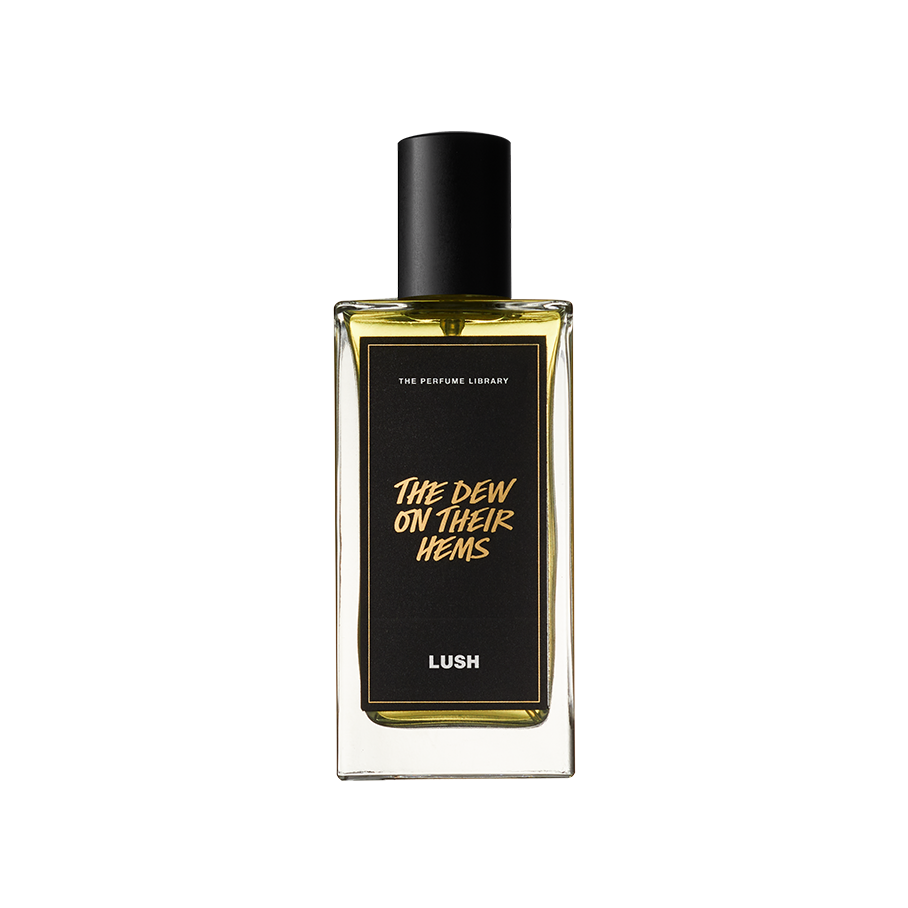 A Dew On Their Hems. A rectangular, glass perfume bottle with a black cap is filled with translucent, amber liquid. A black label reads 'The Dew On Their Hems'.