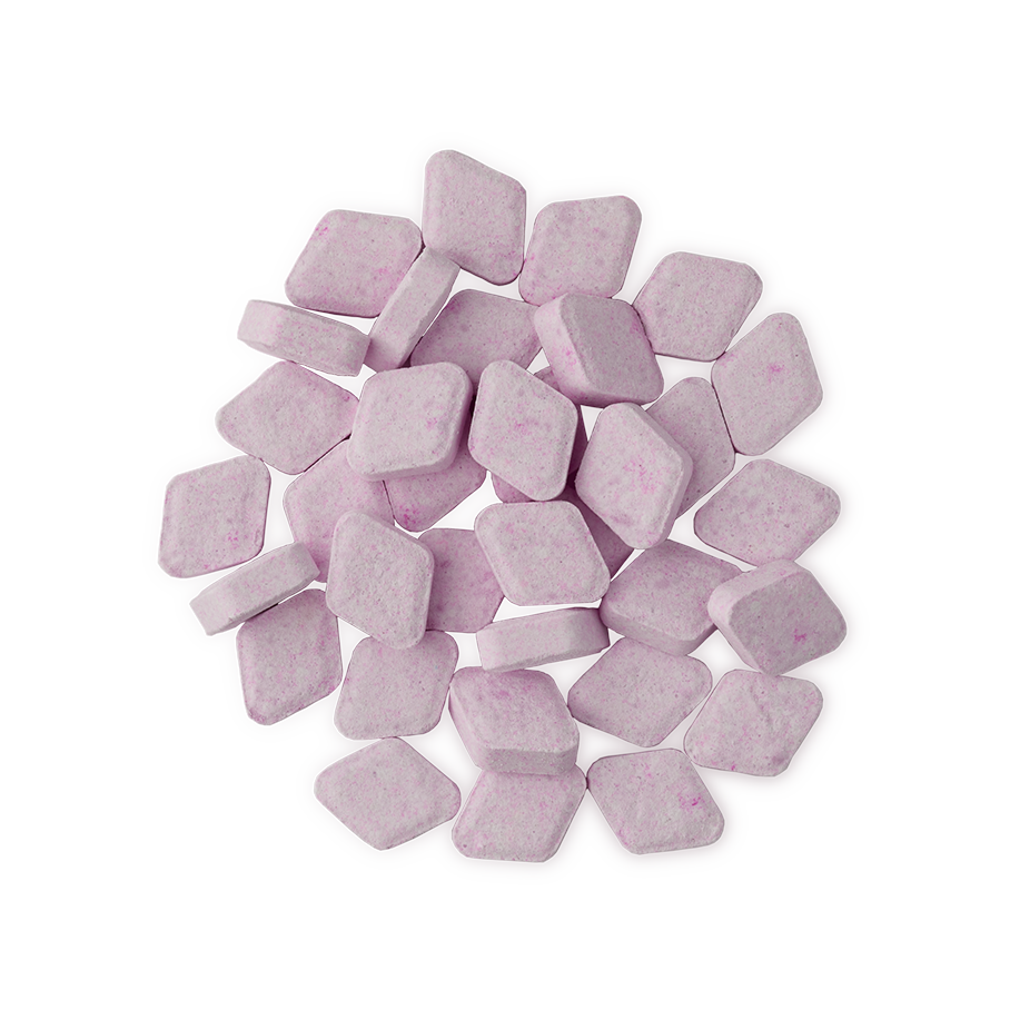 The Kiss. A small pile of about three dozen, pastel pink, chalky, rounded-diamond-shaped mouthwash tablets.