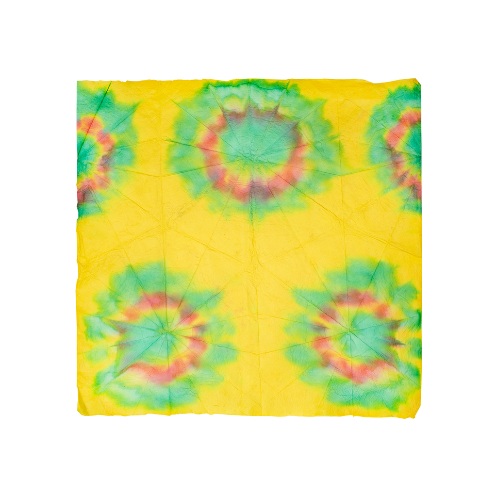 A square Lokta Wrap with yellow, red and blue tie-dyed designs all over.