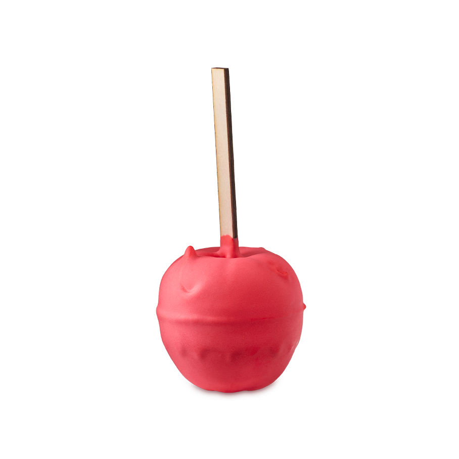 Toffee Apple. A whimsical bath bomb shaped like a bright red candy apple on a thick wooden stick, coated in a smooth, matte red layer.