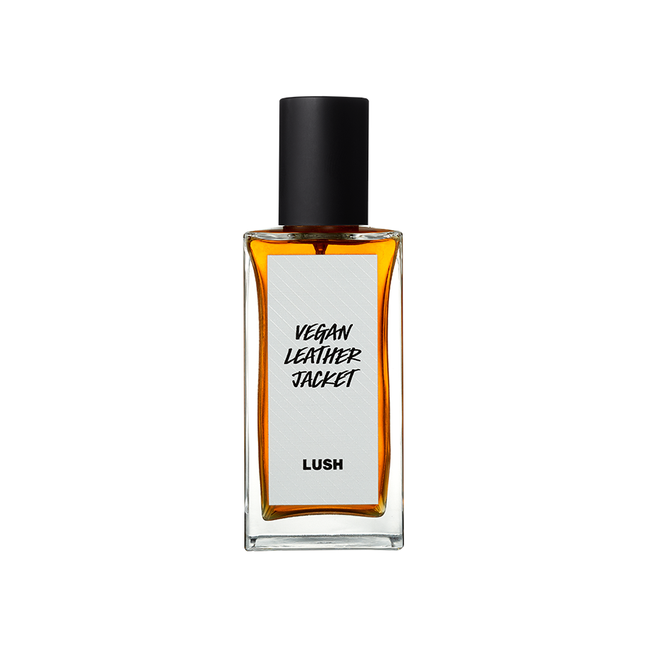 Vegan Leather Jacket. A rectangular, glass perfume bottle with a black cap is filled with translucent, amber liquid. A white label reads 'Vegan Leather Jacket'.