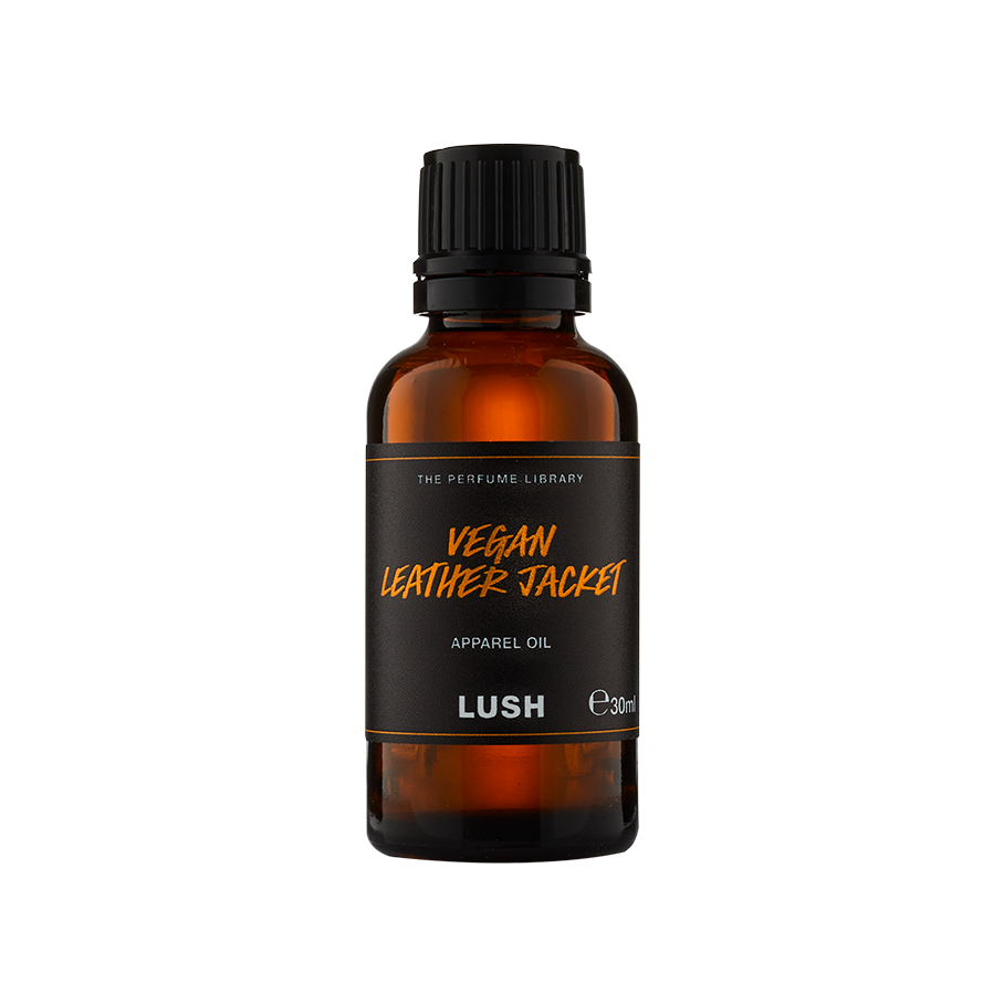 Vegan Leather jacket. The image shows the Vegan Leather Jacket apparel oil packaging. A small, essential oil-style, brown, glass bottle with a black, twist cap. A black label around the middle with the product name in bronze letters.
