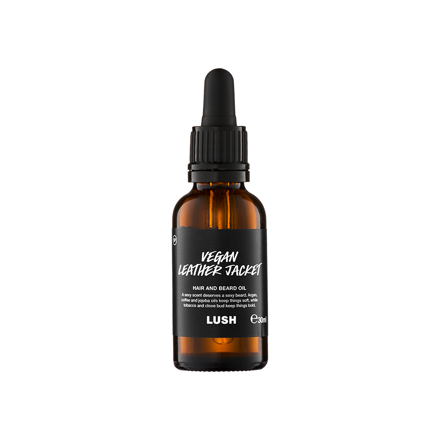 A small, amber glass bottle of "Vegan Leather Jacket" hair and beard oil by Lush. The bottle features a black label with white text and a black pipette dropper lid, containing 30ml of product.