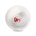 A top-down view of the Wedding bath bomb depicts a shimmering, pearlescent white sphere against a solid black background. An embossed heart shape on the surface reveals a realistic pink rosebud inside its center.
